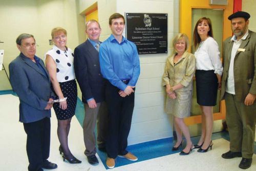 George Beavis, Suzanne Ruttan, Jeff Sanderson, Connor Bayers, Brenda Hunter, Laurie French and David Jackson pose at the new plaque dedicating Sydenham High School's new 14,000 square foot Wellness Wing